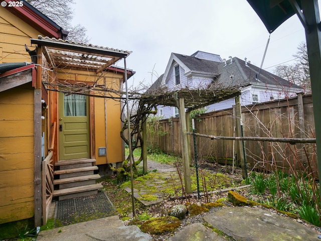 view of yard with fence and entry steps