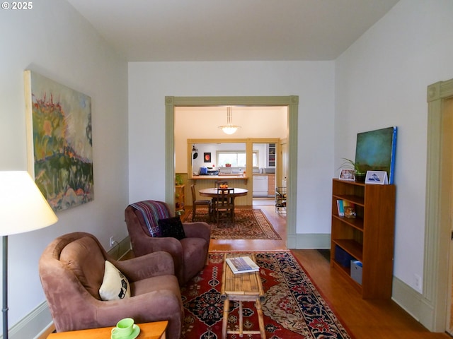 living area with wood finished floors and baseboards