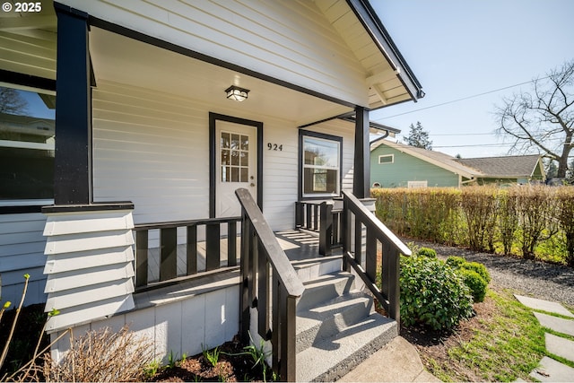 view of exterior entry with a porch