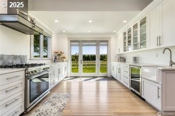 53139 Appleton Rd, Milton-Freewater, OR 97862 - kitchen featuring high end stainless steel range, beverage cooler, a sink, white cabinets, and recessed lighting