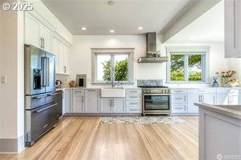 53139 Appleton Rd, Milton-Freewater, OR 97862 - kitchen with high end fridge, oven, wall chimney exhaust hood, healthy amount of natural light, and recessed lighting