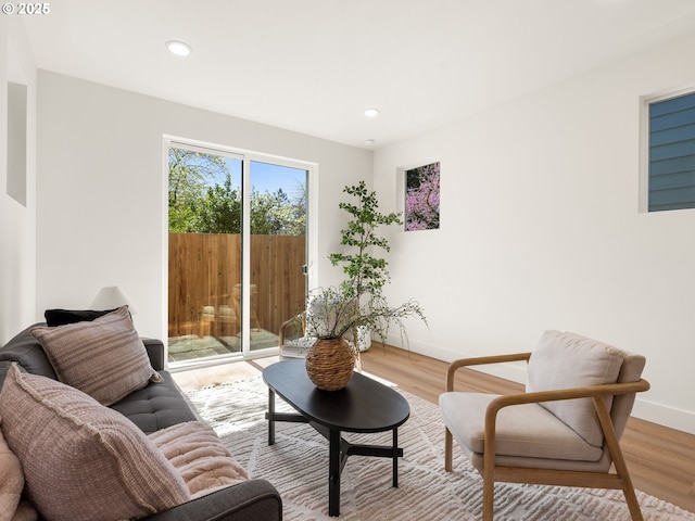 living room with light wood finished floors, baseboards, and recessed lighting