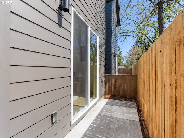 view of side of property featuring fence