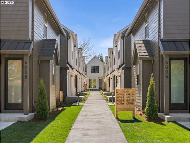 view of community with a yard and a residential view