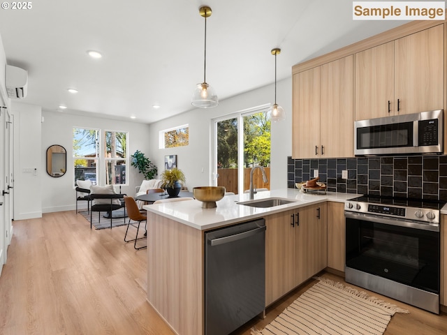 kitchen with tasteful backsplash, a sink, light countertops, light brown cabinetry, and stainless steel appliances