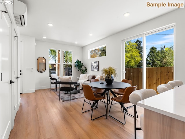 dining area featuring light wood-style floors, recessed lighting, and a wealth of natural light