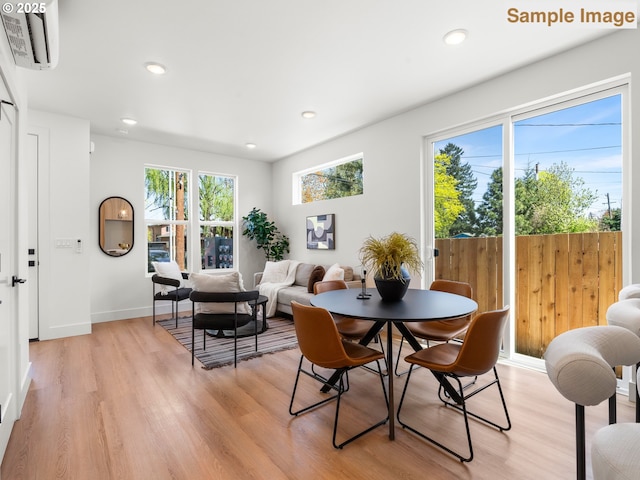 dining area featuring recessed lighting, light wood finished floors, and baseboards