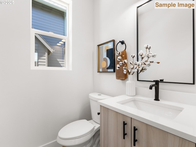 bathroom featuring toilet and vanity