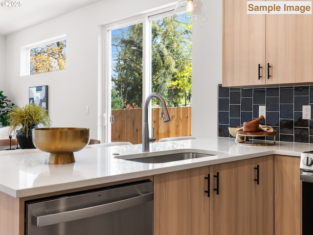 kitchen with light brown cabinets, backsplash, modern cabinets, dishwasher, and a sink