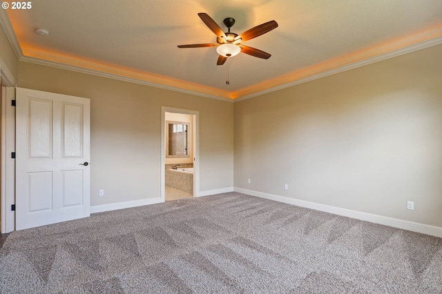unfurnished bedroom with carpet, crown molding, baseboards, ensuite bathroom, and a ceiling fan