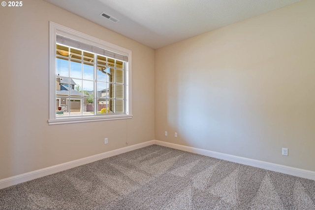 empty room with carpet floors and baseboards
