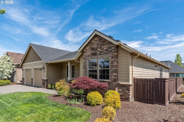 view of front of house with stone siding, a garage, asphalt driveway, and roof with shingles