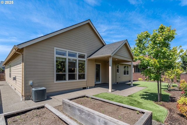 view of front of house with a patio, central AC unit, and a garden