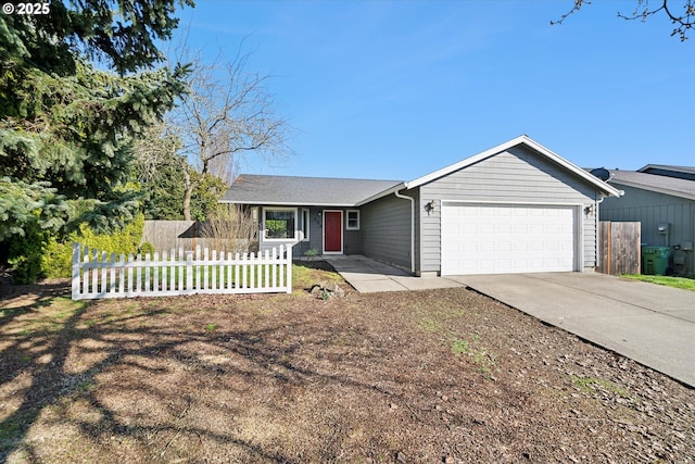 single story home with concrete driveway, an attached garage, and fence