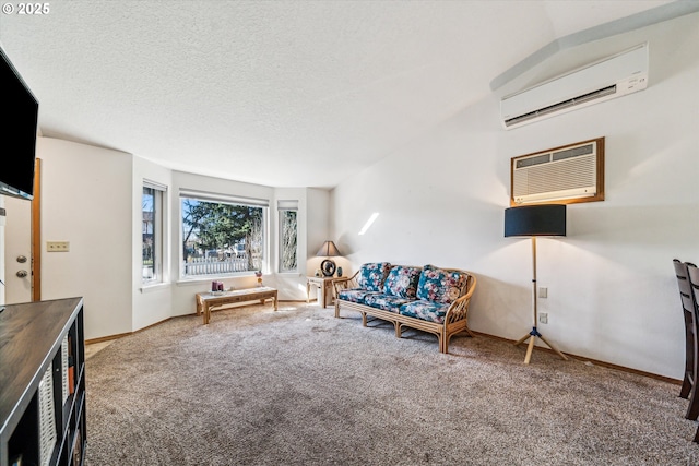 unfurnished room with baseboards, a wall unit AC, a textured ceiling, an AC wall unit, and carpet floors