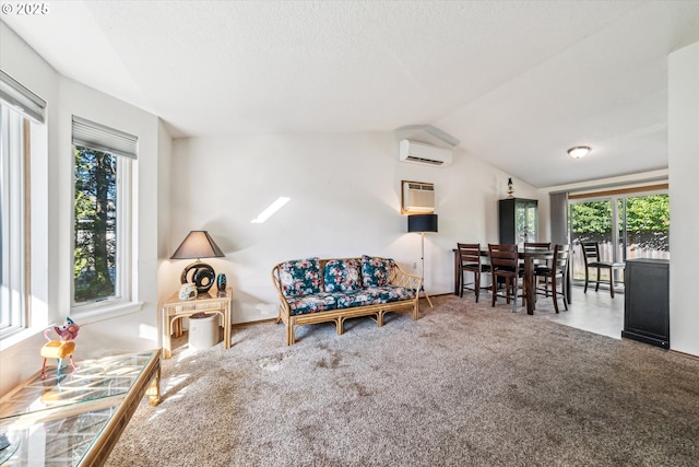 living room with a wall unit AC, carpet, vaulted ceiling, and a wall mounted air conditioner