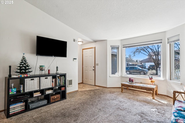 carpeted living room featuring lofted ceiling, visible vents, a textured ceiling, and baseboards