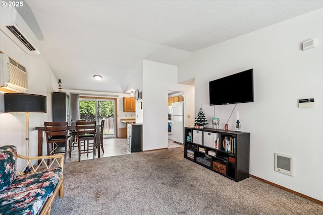 carpeted living room with visible vents, baseboards, vaulted ceiling, an AC wall unit, and a wall mounted AC