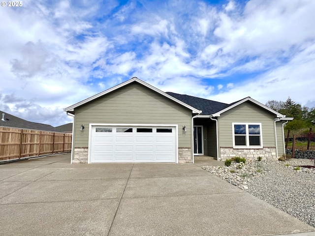 947 Medina Ave, Sutherlin, OR 97479 - ranch-style home with driveway, fence, stone siding, and a garage