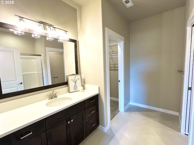 947 Medina Ave, Sutherlin, OR 97479 - full bathroom with a spacious closet, visible vents, baseboards, and vanity