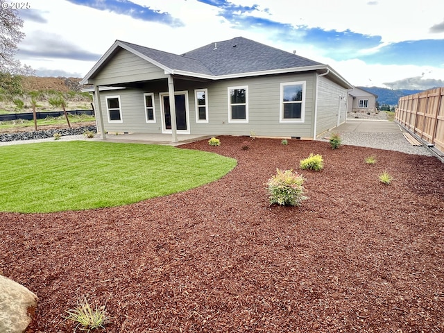 947 Medina Ave, Sutherlin, OR 97479 - back of property featuring a patio area, fence, a yard, and a shingled roof