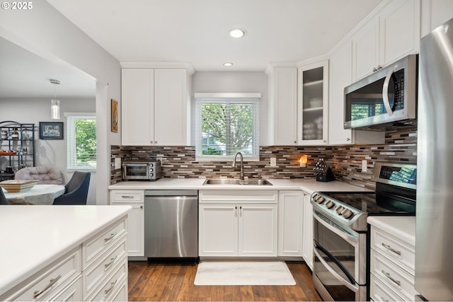 17622 NW Rolling Hill Ln, Beaverton, OR 97006 - kitchen featuring appliances with stainless steel finishes, a sink, backsplash, healthy amount of natural light, and recessed lighting