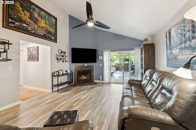 17622 NW Rolling Hill Ln, Beaverton, OR 97006 - living room featuring a ceiling fan, high vaulted ceiling, light wood-type flooring, a tile fireplace, and baseboards