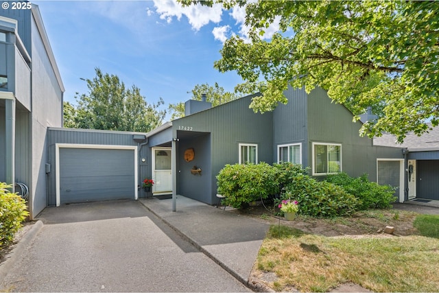 17622 NW Rolling Hill Ln, Beaverton, OR 97006 - mid-century inspired home with an attached garage, driveway, and a chimney