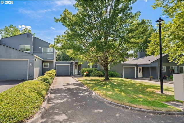 17622 NW Rolling Hill Ln, Beaverton, OR 97006 - mid-century inspired home with asphalt driveway, a garage, and a front yard