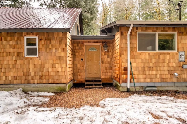 entrance to property with crawl space and metal roof