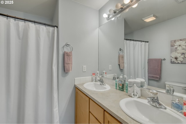 full bathroom featuring double vanity and a sink