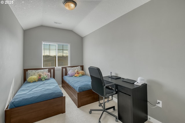 bedroom with light colored carpet, vaulted ceiling, visible vents, and a textured ceiling