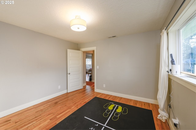 interior space featuring hardwood / wood-style floors and a textured ceiling