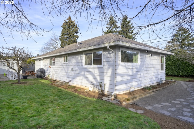 view of property exterior featuring a lawn