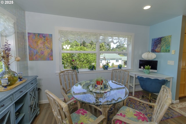 dining space featuring recessed lighting, baseboards, and wood finished floors