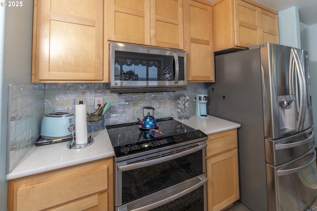 kitchen featuring backsplash, light brown cabinetry, and stainless steel appliances