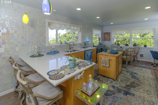 kitchen featuring recessed lighting, a sink, and a wealth of natural light