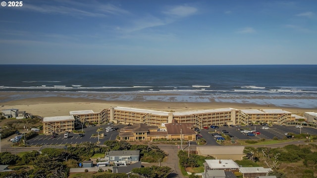 drone / aerial view featuring a water view and a beach view