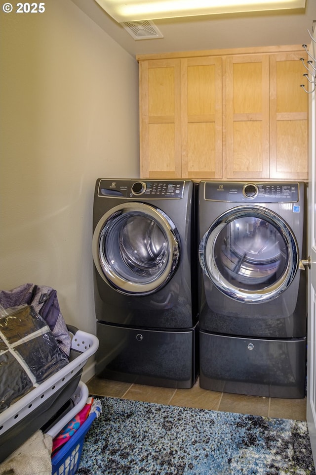 laundry room with washer and dryer, visible vents, laundry area, and tile patterned flooring