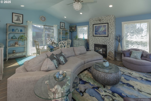 living room featuring a healthy amount of sunlight, lofted ceiling, a ceiling fan, and wood finished floors