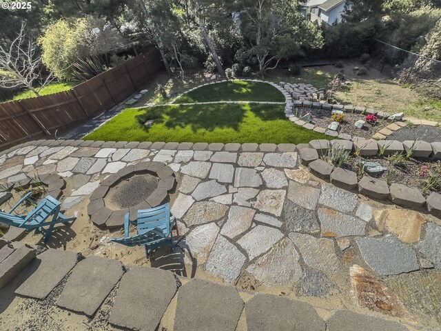 view of yard featuring fence and an outdoor fire pit