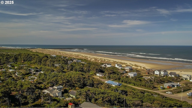 drone / aerial view featuring a beach view and a water view