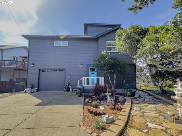 back of house featuring driveway and a garage