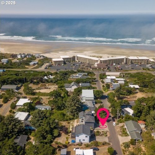 birds eye view of property featuring a view of the beach and a water view