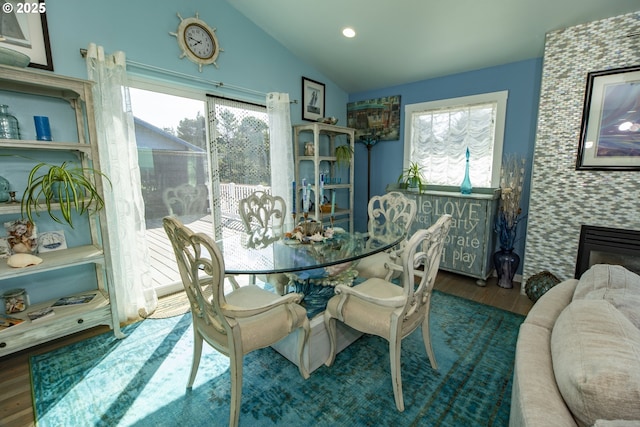 dining room with recessed lighting, wood finished floors, and vaulted ceiling