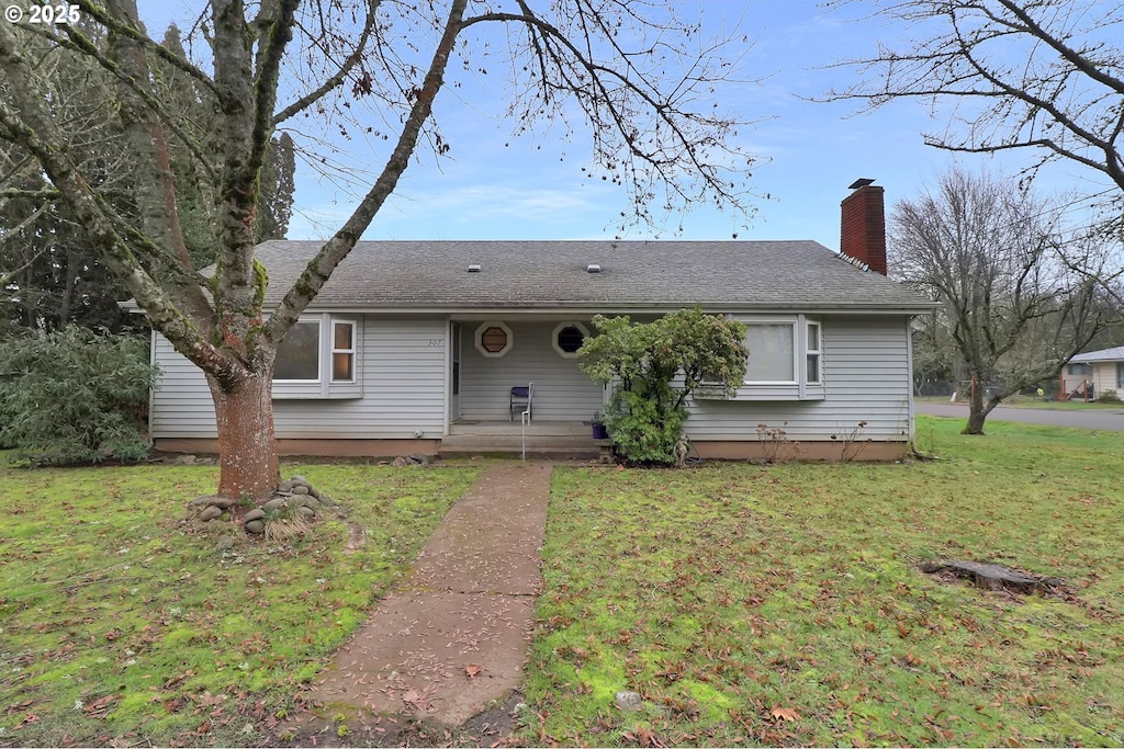 ranch-style house with a front lawn