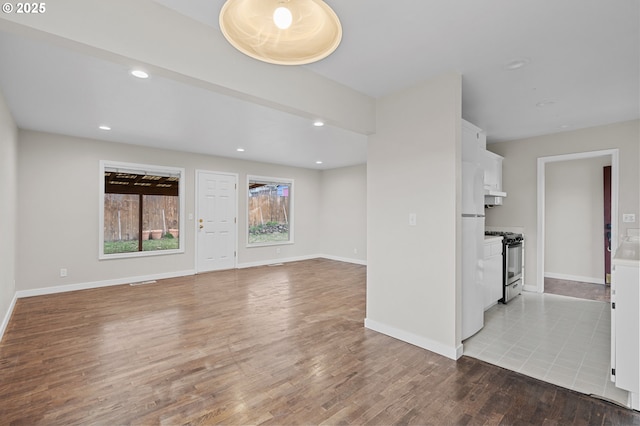 unfurnished living room featuring light hardwood / wood-style flooring