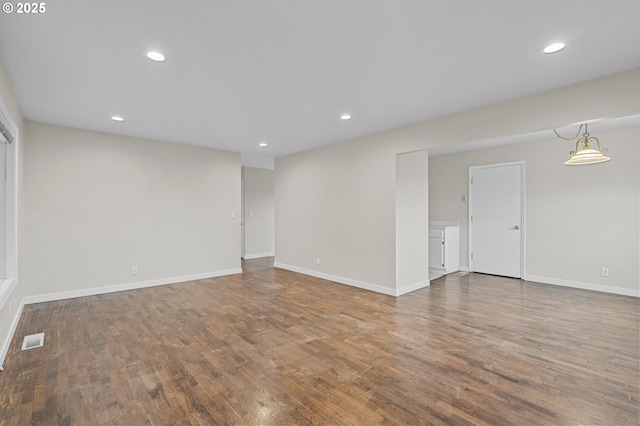 empty room with hardwood / wood-style flooring