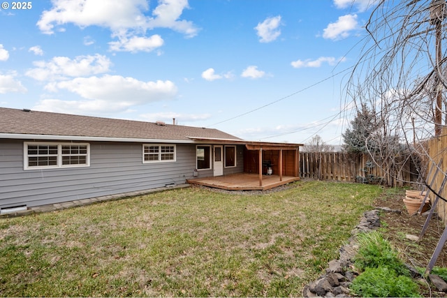 back of property featuring a wooden deck and a yard