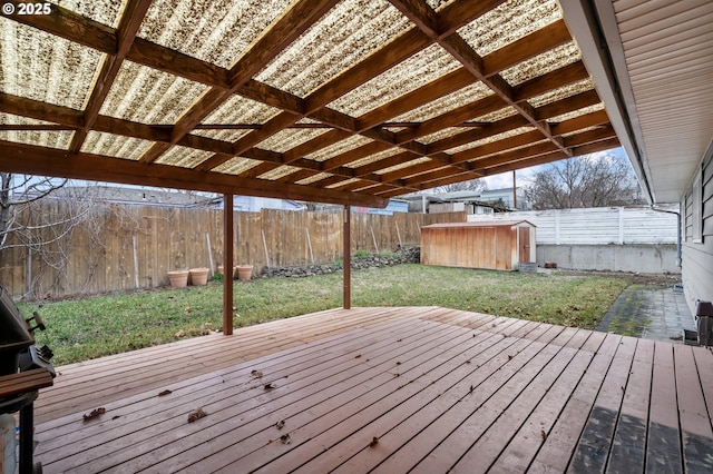 deck with a shed and a yard